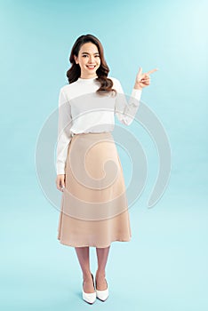 Smiling business woman pointing finger on copy space. isolated portrait