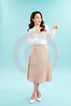 Smiling business woman pointing finger on copy space.  portrait