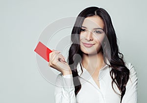 Smiling business woman with red blank card.