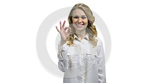 Smiling business woman showing ok sign.
