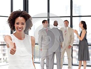 Smiling business woman showing team spirit