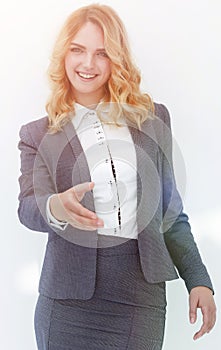 Smiling business woman stretching hand for handshake.