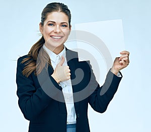 Smiling business woman in suit holding white blank sign board.