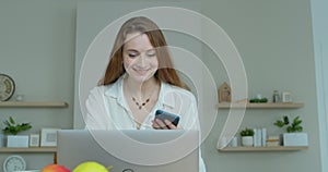 Smiling business woman talking mobile phone at home office. Portrait of joyful girl making phone call at remote