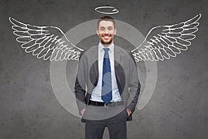 Smiling businessman with angel wings and nimbus