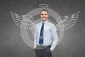 Smiling businessman with angel wings and nimbus
