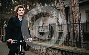 Smiling businessman with bicycle enjoying a break outdoors