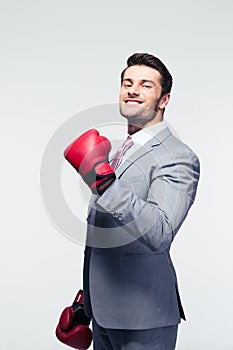 Smiling businessman in boxing gloves