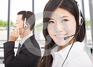 Smiling businessman with call center agent