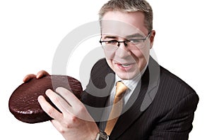Smiling businessman with chocolate pie in hands