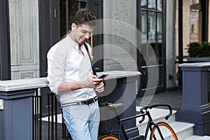 Smiling businessman dressed in shirt standing outdoors