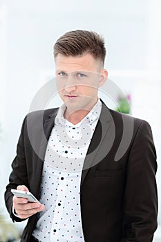 Smiling businessman in eyeglasses talking on the phone