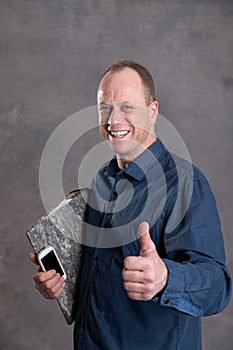 Smiling businessman with folder,  phone and thumb up