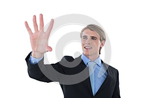 Smiling businessman gesturing on invisible interface
