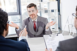 Smiling businessman gesturing during job interview