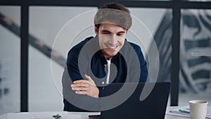 Smiling businessman getting good news on email. Cheerful guy working laptop