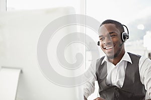 Smiling businessman with headset interacting