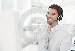 Smiling businessman with headset interacting