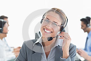 Smiling businessman with headsets looking at camera