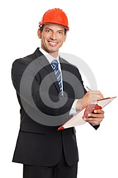 Smiling businessman in a helmet