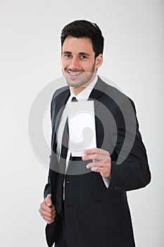 Smiling businessman hodling blank paper