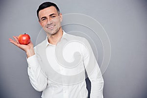 Smiling businessman holding apple