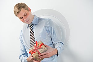 Smiling businessman holding gift box