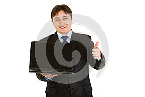 Smiling businessman holding laptops blank screen