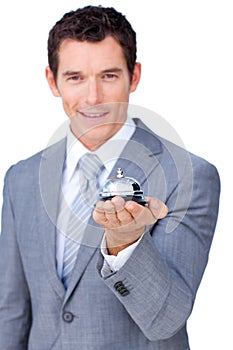 Smiling businessman holding a service bell