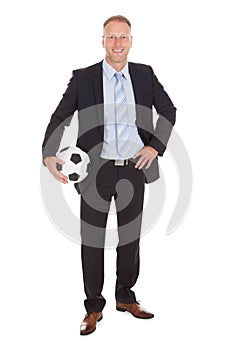 Smiling Businessman Holding Soccer Ball