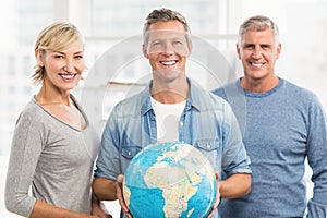 Smiling businessman holding terrestrial globe