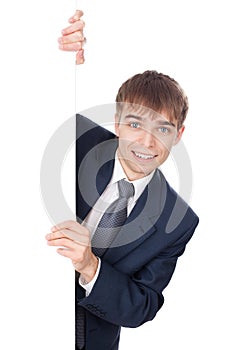 Smiling businessman holding white blank board