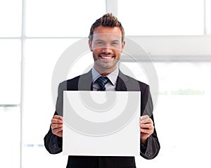 Smiling businessman holding a white card