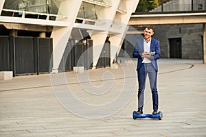 Smiling businessman on hoverboard.