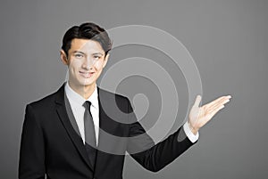 Smiling businessman introducing something