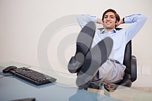 Smiling businessman leaning back in his chair