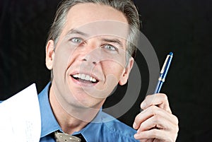 Smiling Businessman Offers Pen