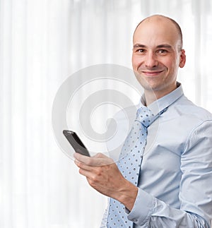 Smiling businessman with phone