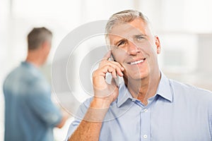 Smiling businessman on the phone