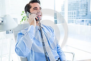 Smiling businessman phoning