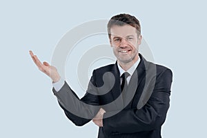 Smiling businessman pointing copy space.