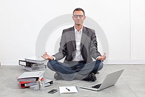 Smiling businessman practicing yoga at office for relaxation