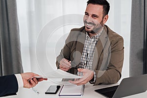 Smiling businessman preparing signing contract with client