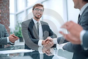 Smiling businessman shaking hands with his business partner
