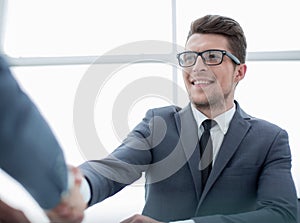 Smiling businessman shaking hands with his partner