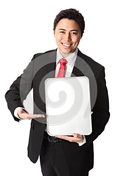 Smiling businessman showing blank board