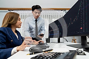 Smiling businessman showing stock market data on phone to woman. Infobahn.