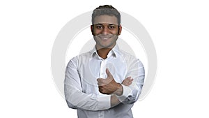 Smiling businessman showing thumb up sign.