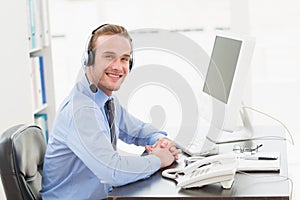 Smiling businessman speaking with headset