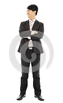 Smiling businessman standing and crossed arms